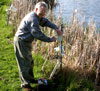 Dr. Whitford installing GooseBuster near lake